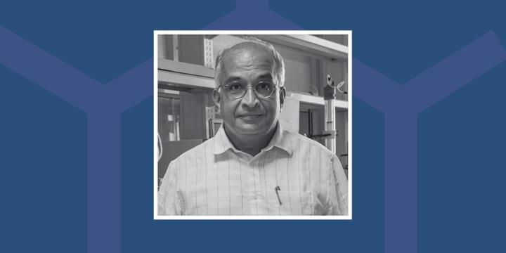 B/W photo of Prof. Jayant Udgaonkar against a blue background