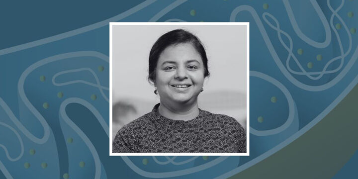 Photo of Prof. Richa Rikhy against a background with a graphic of mitochondria