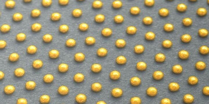 A schematic showing an array of spherical drops representative of nanoparticles formed by confined dewetting process