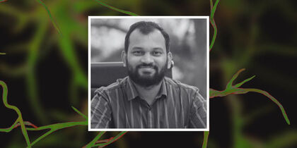 Photo of Dr Borkar against a representative image of neurons